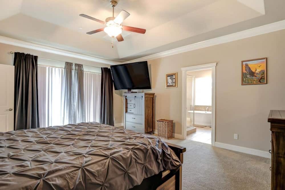 The primary bedroom includes a wall-mounted TV and a private bathroom.