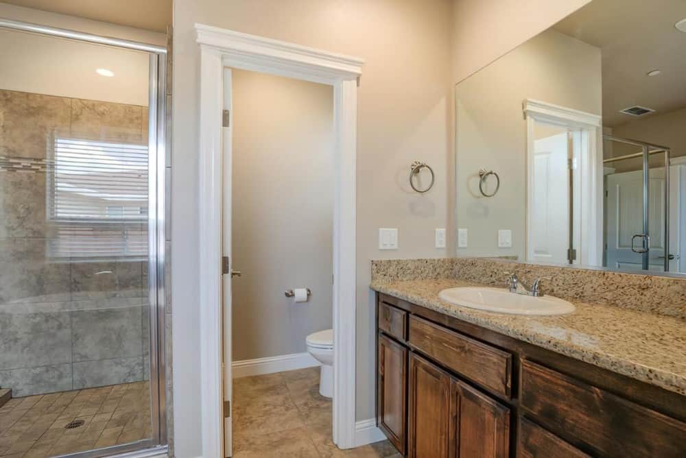 A toilet room completes the primary bathroom.