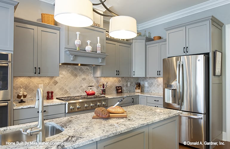 A couple of drum pendants suspended over the island illuminate the kitchen.