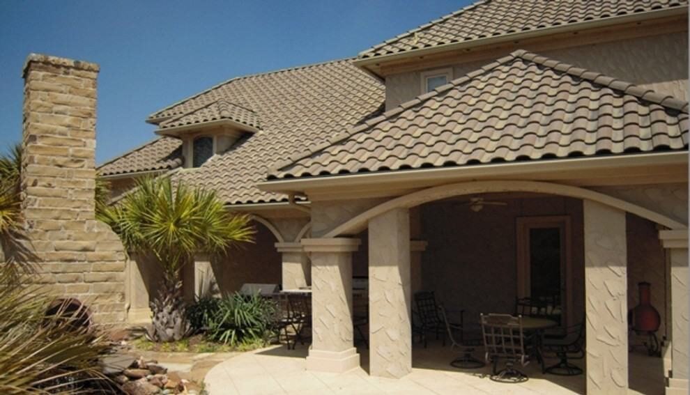 Right exterior view with covered porch lined with large pillars.