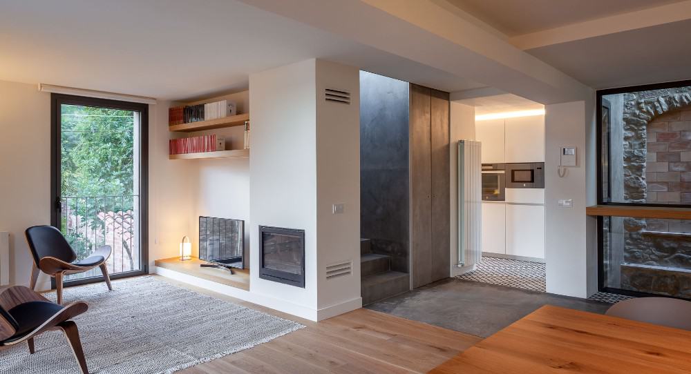 A living room and kitchen on the other side in white interior design.