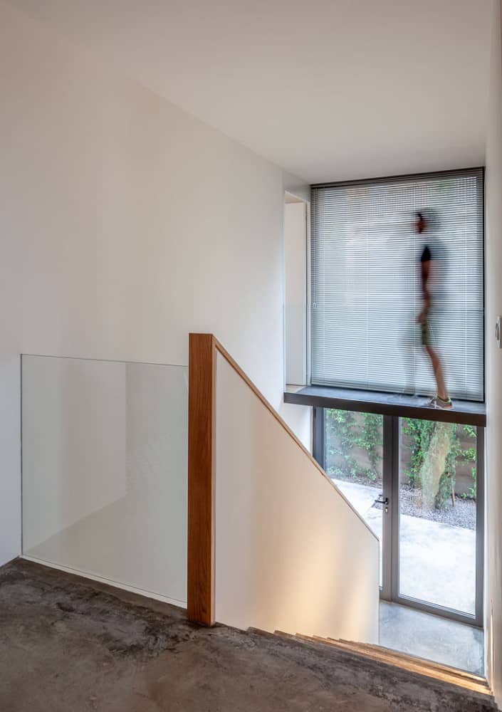 A shot of stairs with sliding door on gray accents.