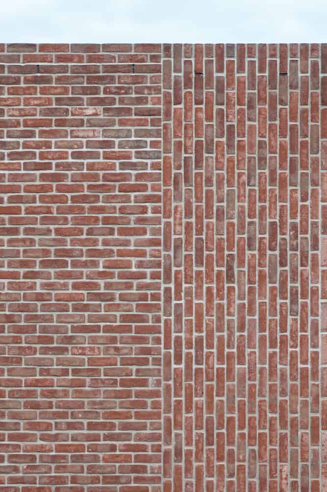 This is a close look at the exterior wall with a close look at the red brick formations of the wall.