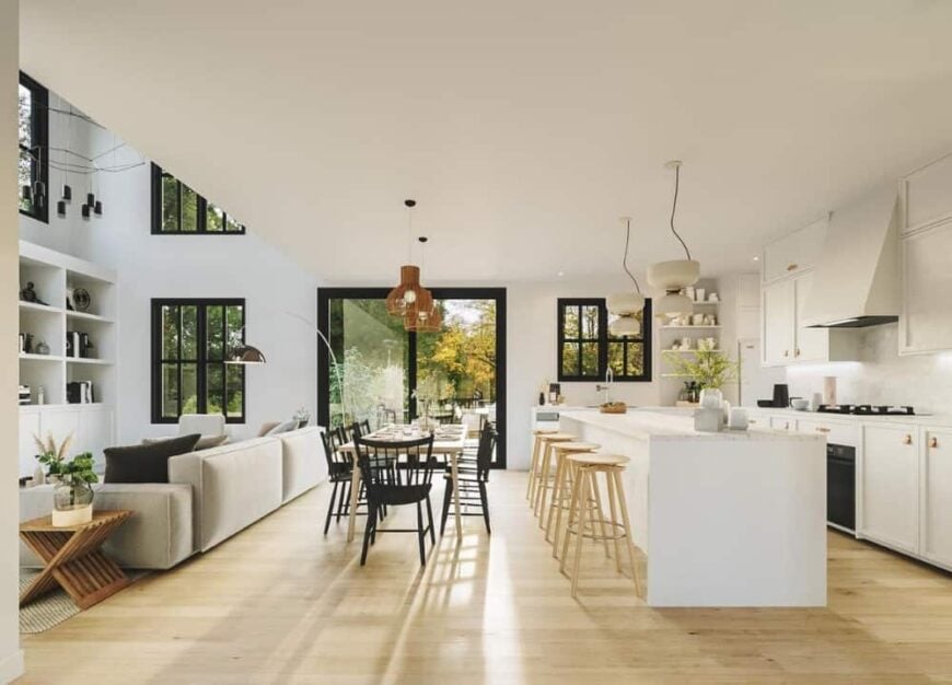 An open layout view showing the kitchen, dining area, and living room with light hardwood flooring.