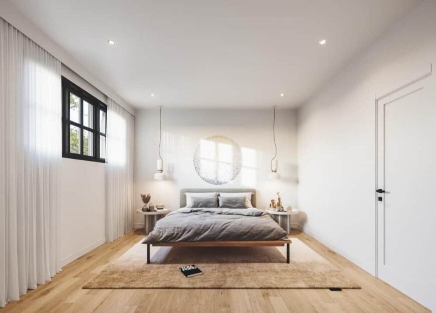Primary bedroom with modern white pendants and a cozy bed complemented with round nightstands.