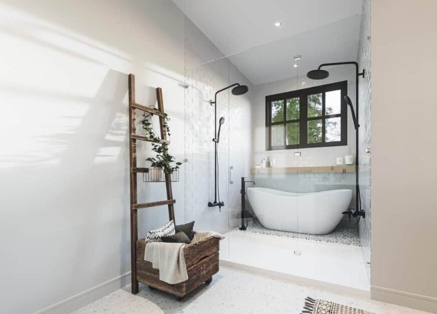 The walk-in shower is equipped with a freestanding tub and two shower heads in a wrought iron finish.