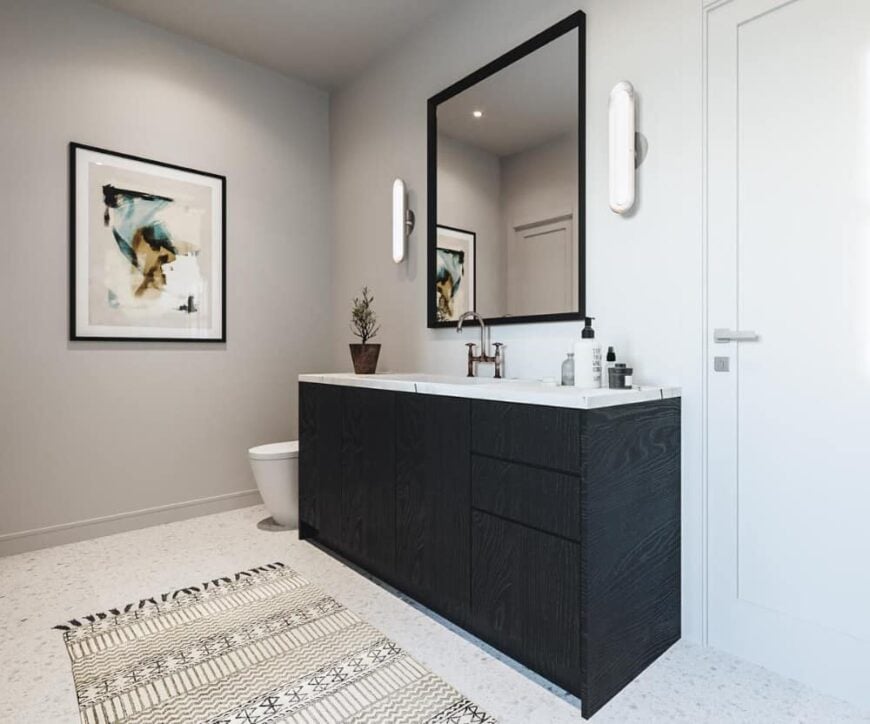 A striped tasseled runner complements the single sink vanity.