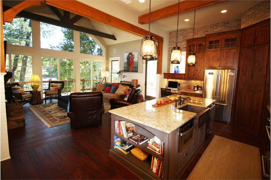 The living room opens to the kitchen equipped with stainless steel appliances and a center island fitted with a farmhouse sink.The living room opens to the kitchen equipped with stainless steel appliances and a center island fitted with a farmhouse sink.