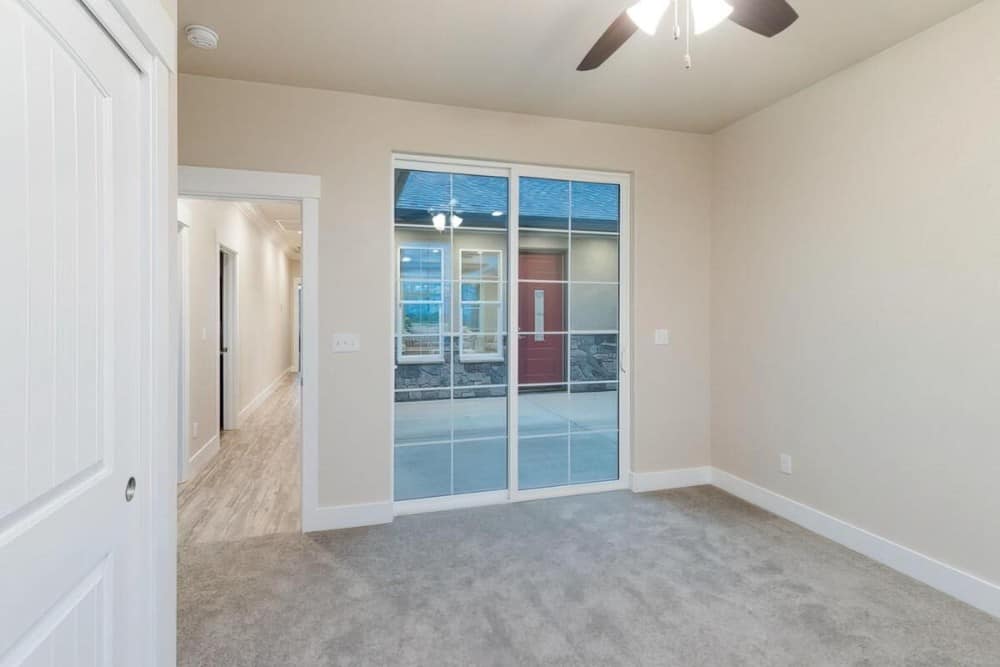 The bedroom includes direct outdoor access through sliding glass doors.