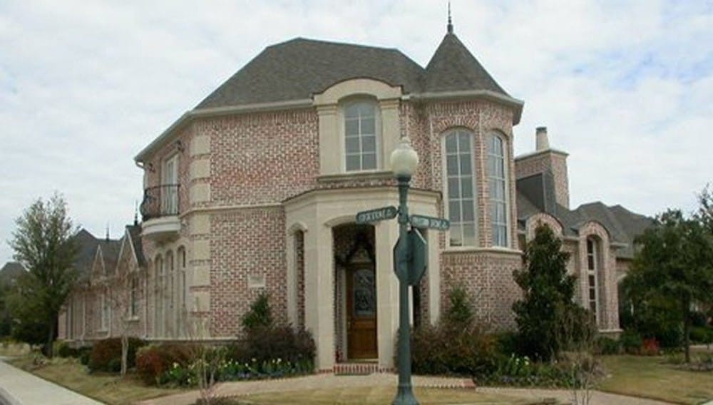 Front exterior view with red brick cladding, hipped rooflines, and a turret.Front exterior view with red brick cladding, hipped rooflines, and a turret.