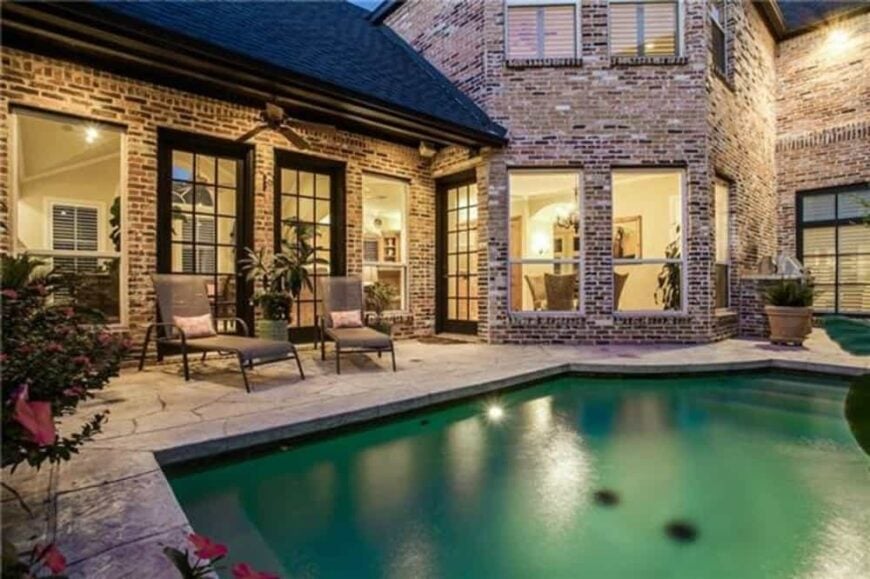Outdoor lounge with metal loungers and a swimming pool.