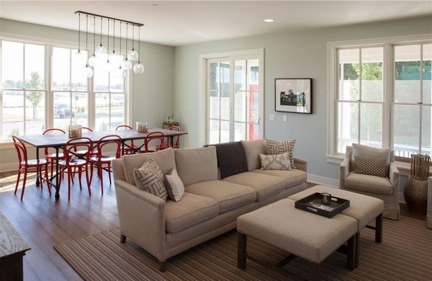 Behind the living room is the dining area with an elongated dining set and glass globe pendants.