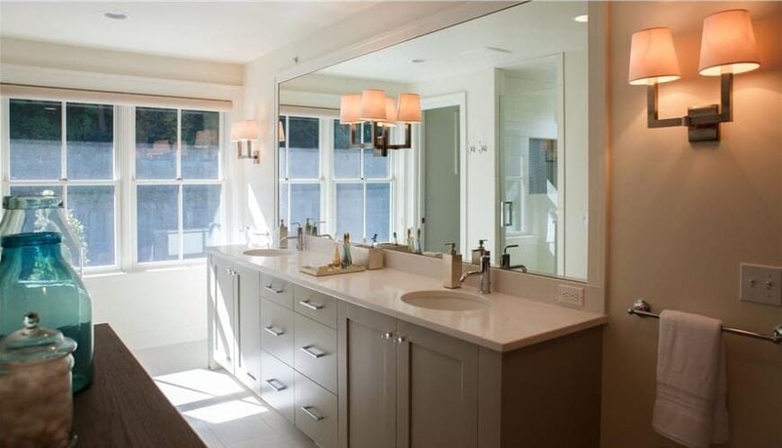 The primary bathroom features a dual sink vanity paired with a large rectangular mirror.