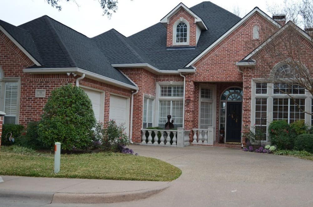An angled view shows the side-entry garage enclosed in white paneled doors.