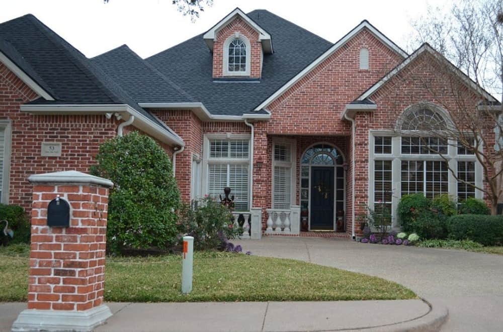 Front exterior view with red brick cladding, a gable dormer, arched windows, and a sleek entry.Front exterior view with red brick cladding, a gable dormer, arched windows, and a sleek entry.