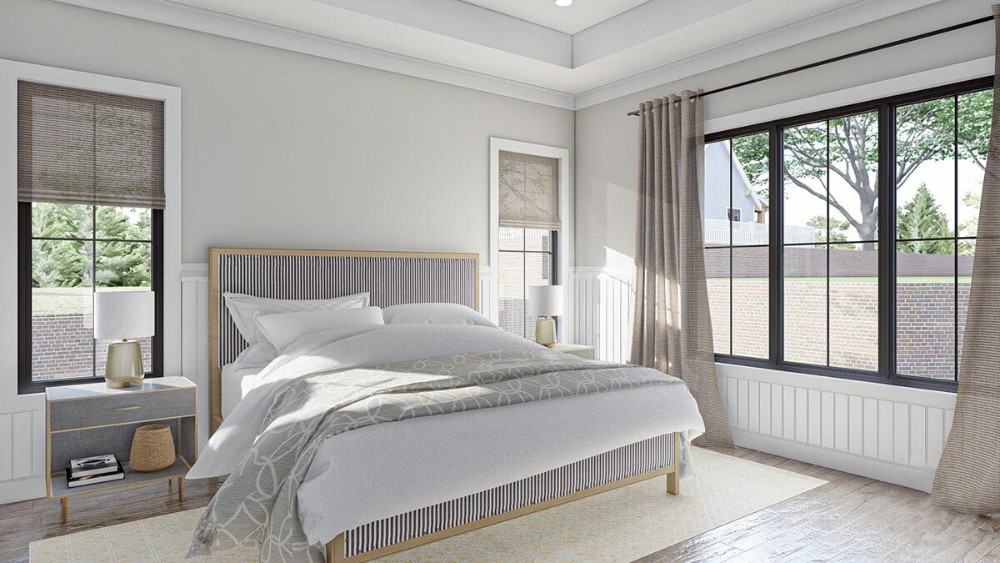 Primary bedroom with a tray ceiling, beadboard accents, and wide plank flooring topped with a beige patterned rug.