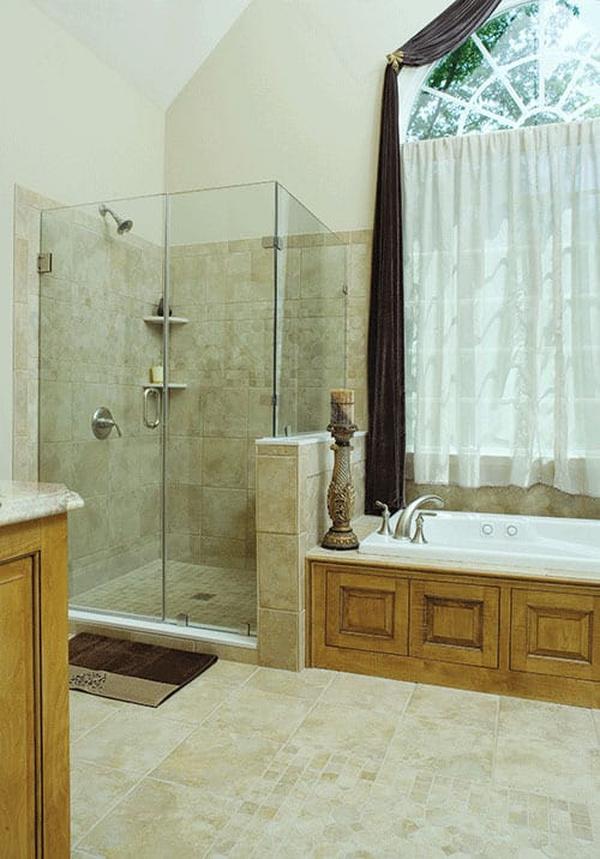 The primary bathroom has a walk-in shower and a drop-in bathtub placed under the arched window.