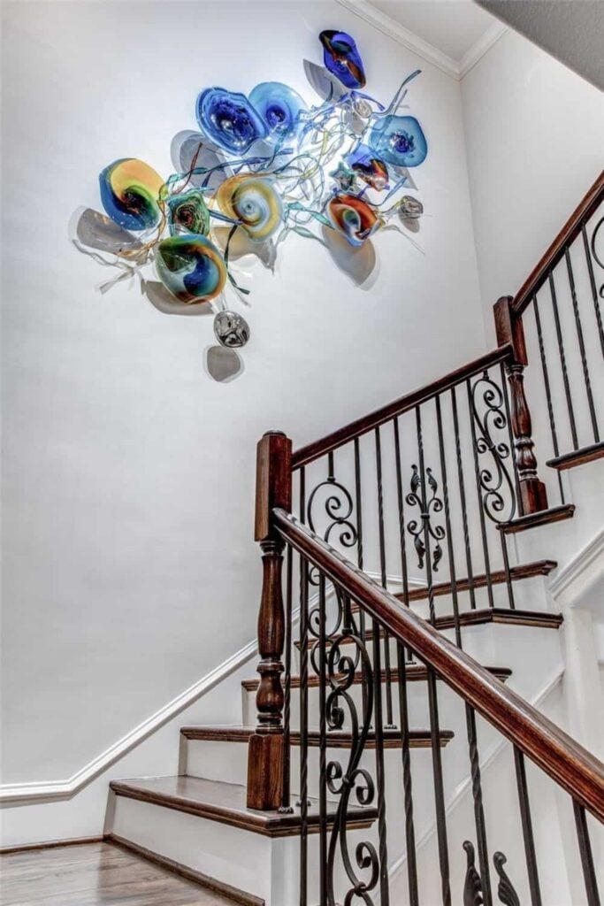 Traditional staircase adorned with huge abstract wall art.