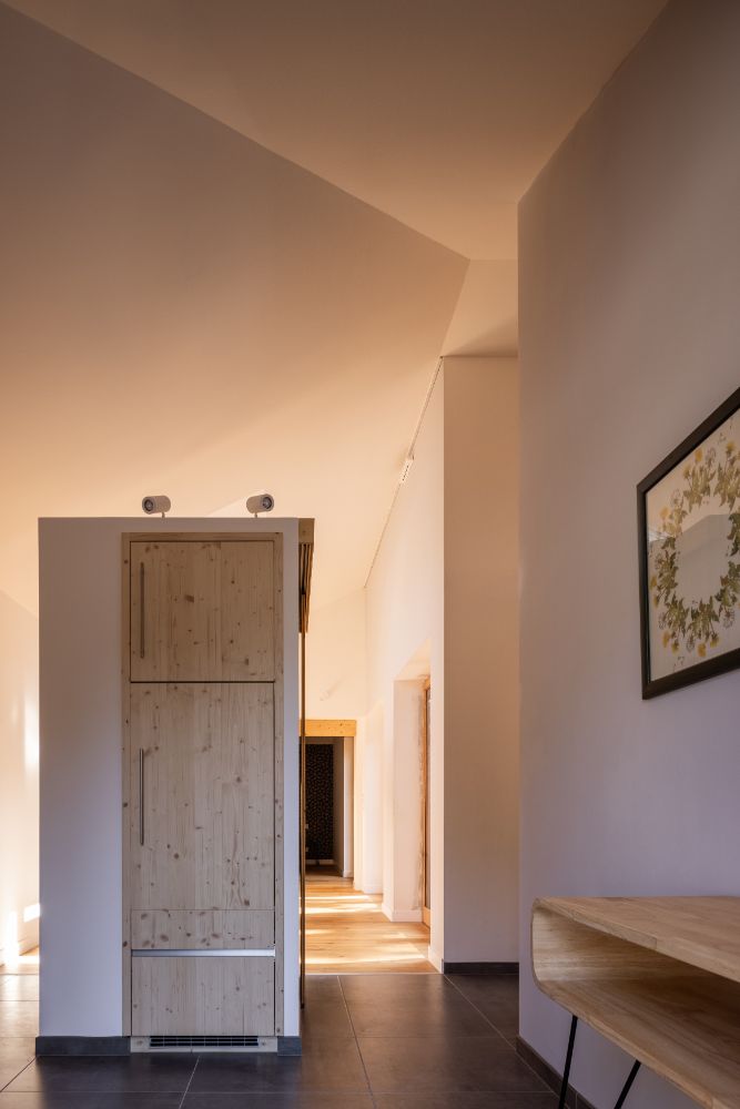 White painted hallway with artwork on the wall.