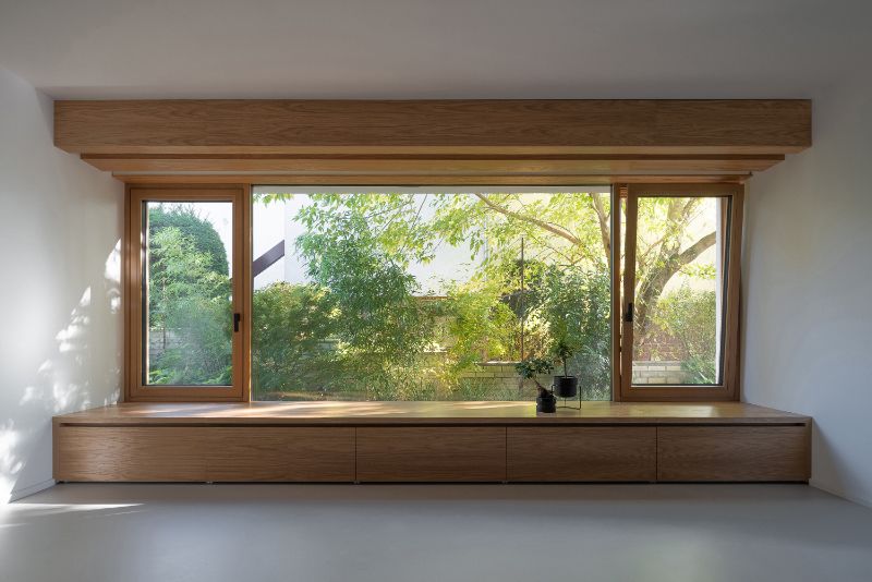 Cherry tree house upper level open space with outside view of trees.
