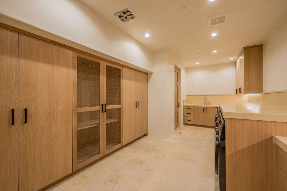 Miele laundry custom-built-steel-and-glass cabinetry.