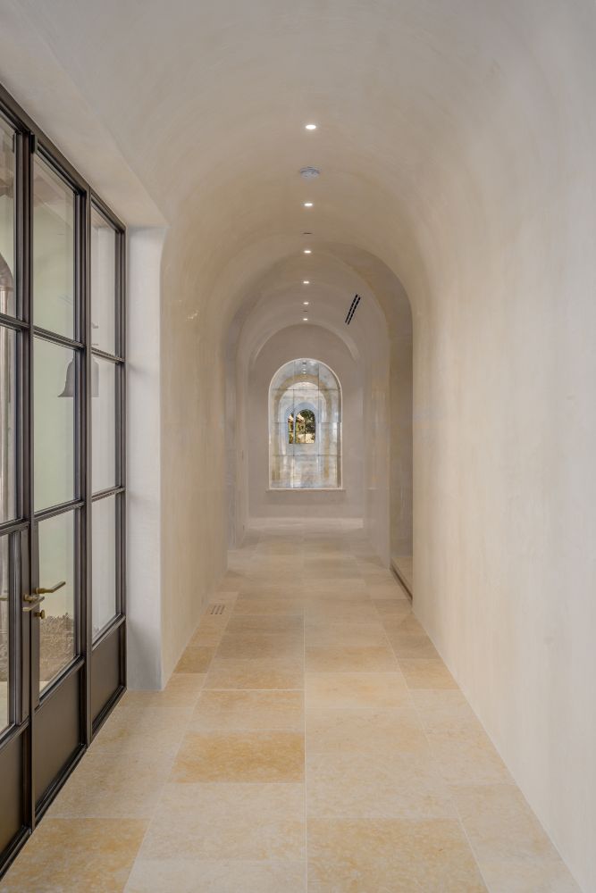 Hallway with barrel type of ceiling and retractable glass door.