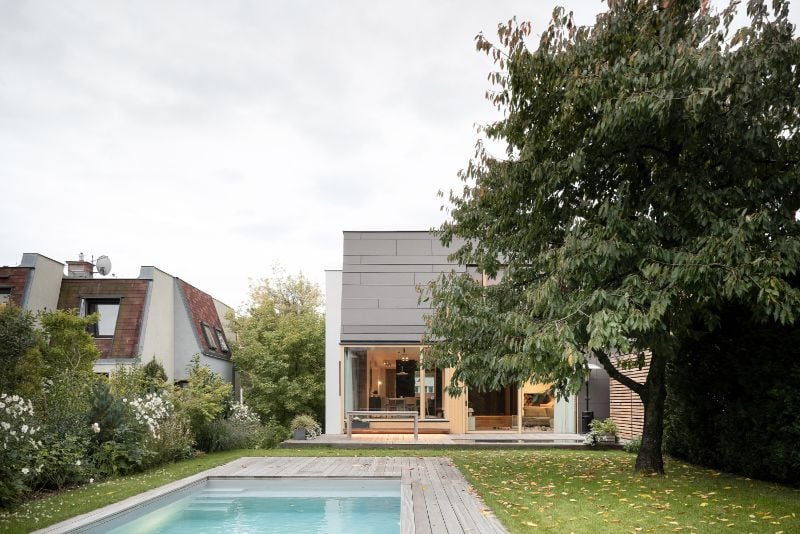Cherry tree house with swimming pool in front and cherry tree.
