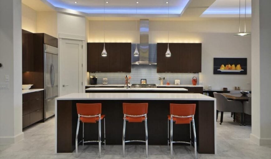 Kitchen with dark wood cabinets, stainless steel appliances, and quartz countertops.