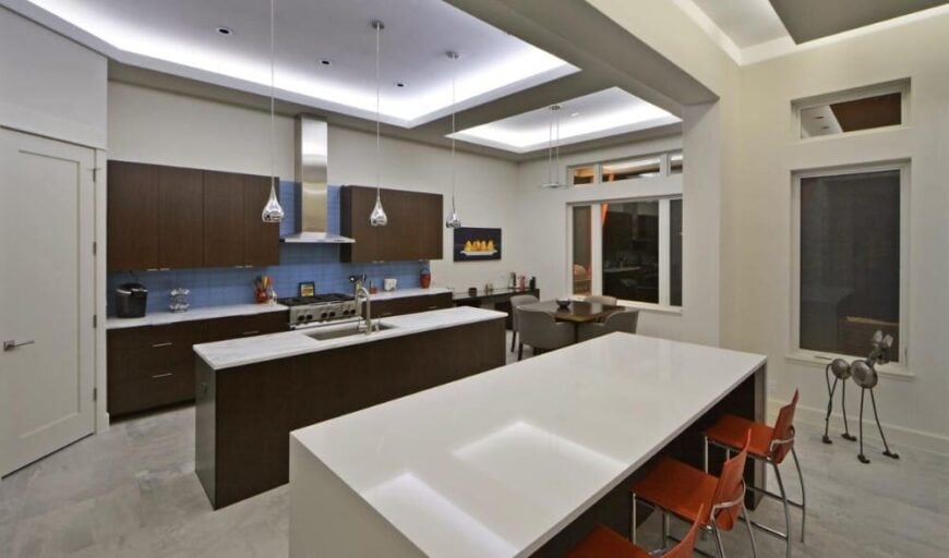 The kitchen includes an adjoining breakfast nook situated against the windows.