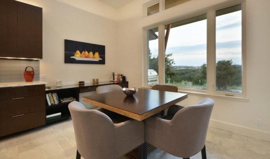 The breakfast nook has a wooden console table and a square dining set with four seating.