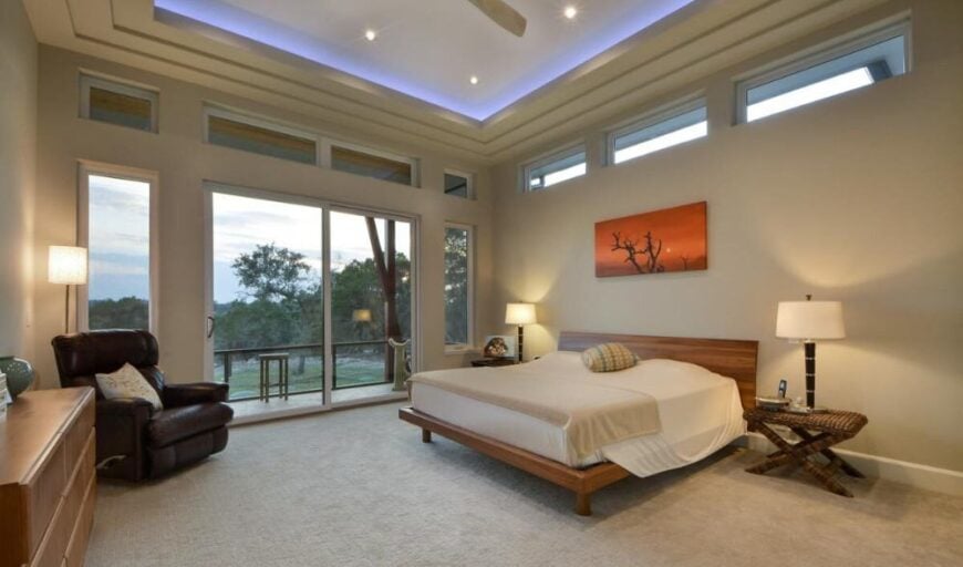 The primary bedroom features a stunning step ceiling and a private porch accessible through sliding glass doors.