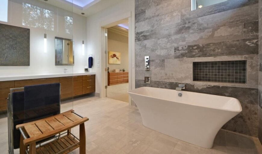 Primary bathroom with dual sink vanity and a shower area with a freestanding tub.