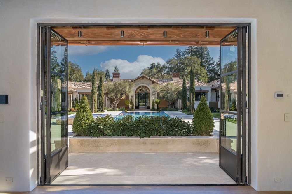 Compound backdoor leading to swimming rectangular pool area.
