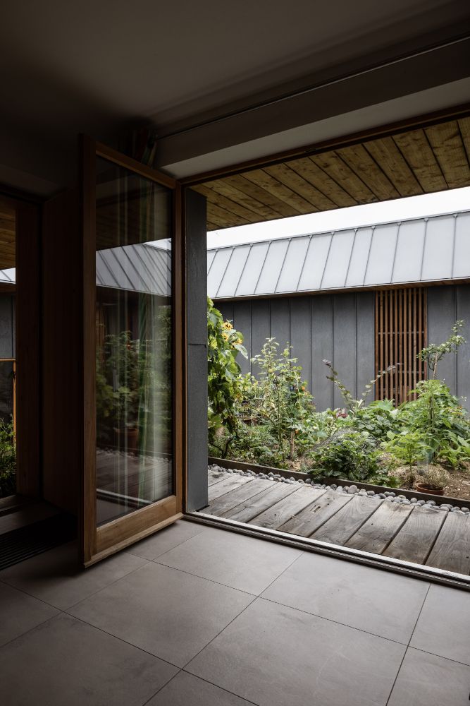House wide main door which is made of glass that has direct view to the garden.