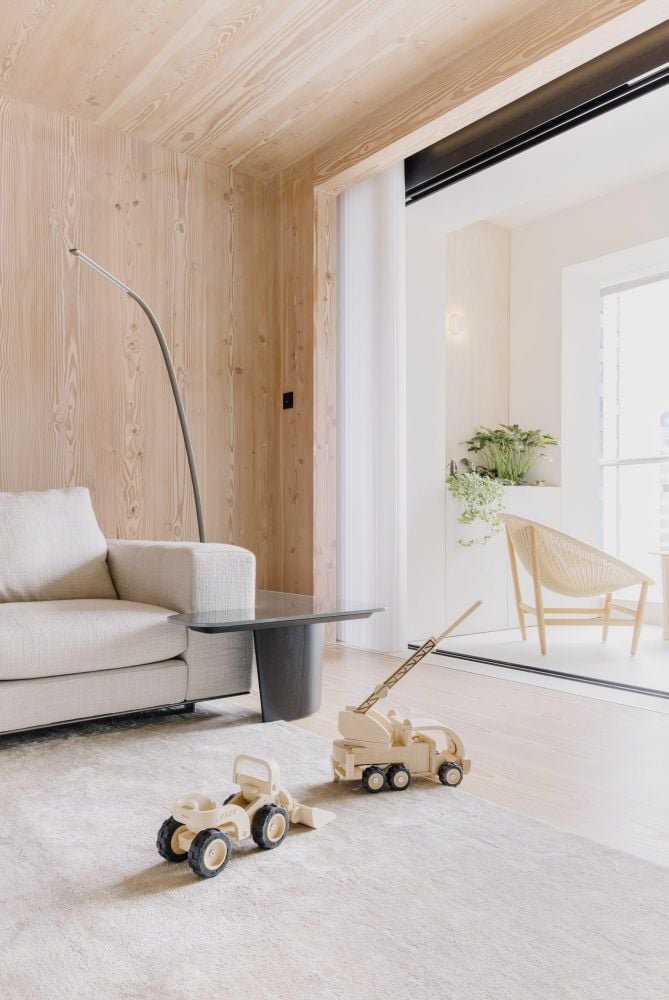Urban cottage living area connecting to balcony.