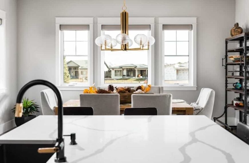 The adjacent dining area offers a 6-seater dining set topped with a contemporary chandelier.