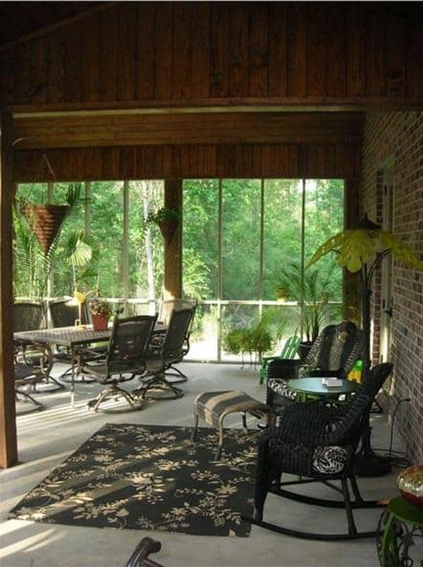 The primary bedroom has carpet flooring and a wrought iron bed complemented with a wooden table at its end.