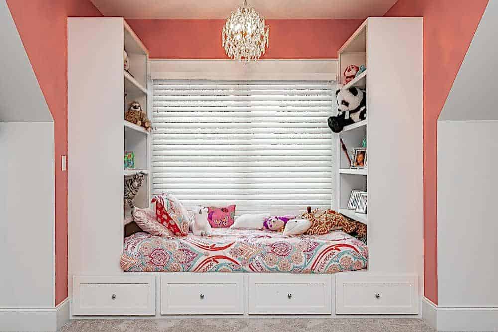 The bedroom includes a window seat nook fitted with built-in shelves and a daybed.