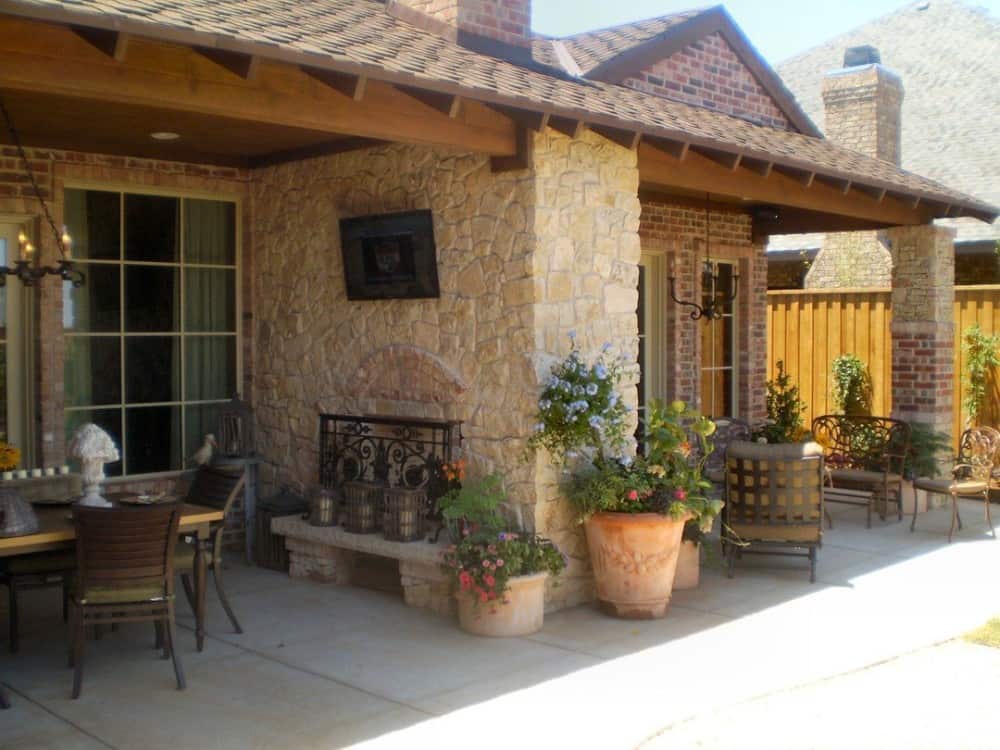 Covered porches at the back with multiple seating areas and a double-sided fireplace.