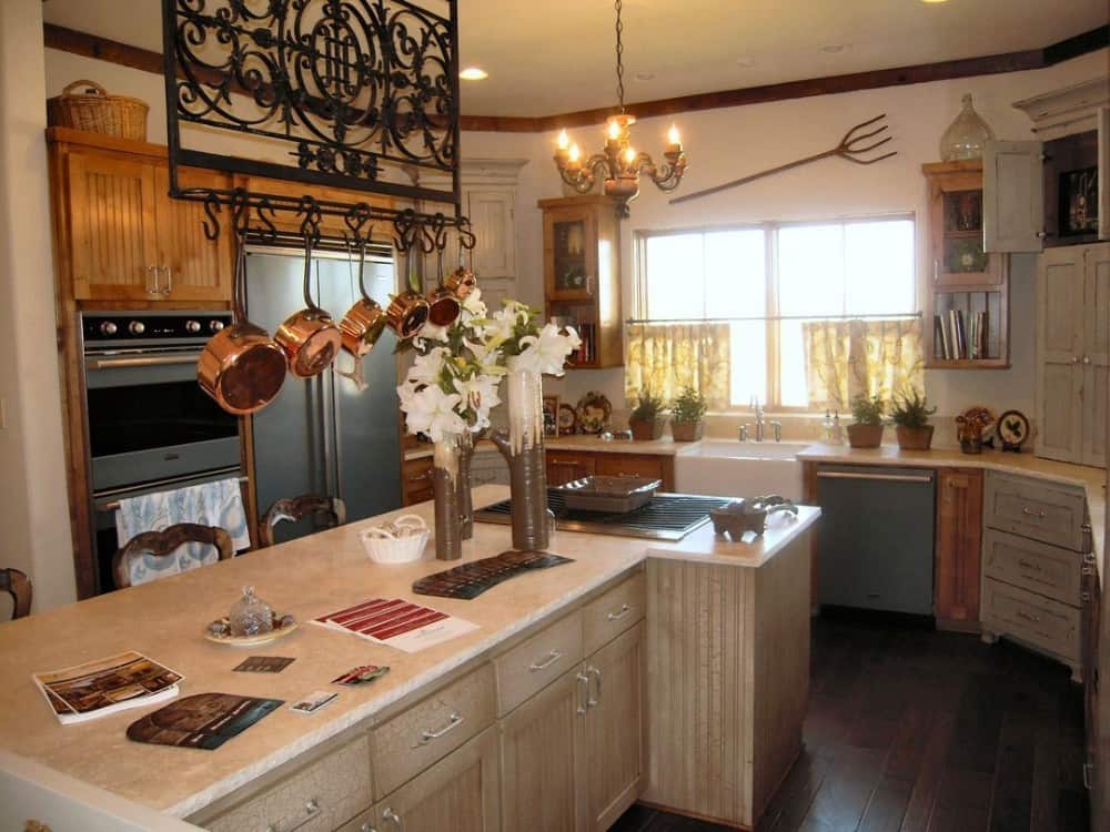 The kitchen offers custom cabinetry, a farmhouse sink, and an ornate pot rack suspended over the breakfast island.The kitchen offers custom cabinetry, a farmhouse sink, and an ornate pot rack suspended over the breakfast island.