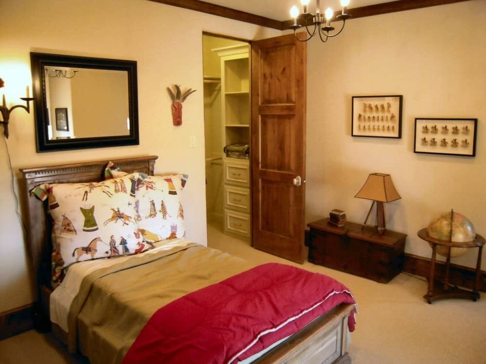 This bedroom offers a single bed and a walk-in closet enclosed in a wooden door.