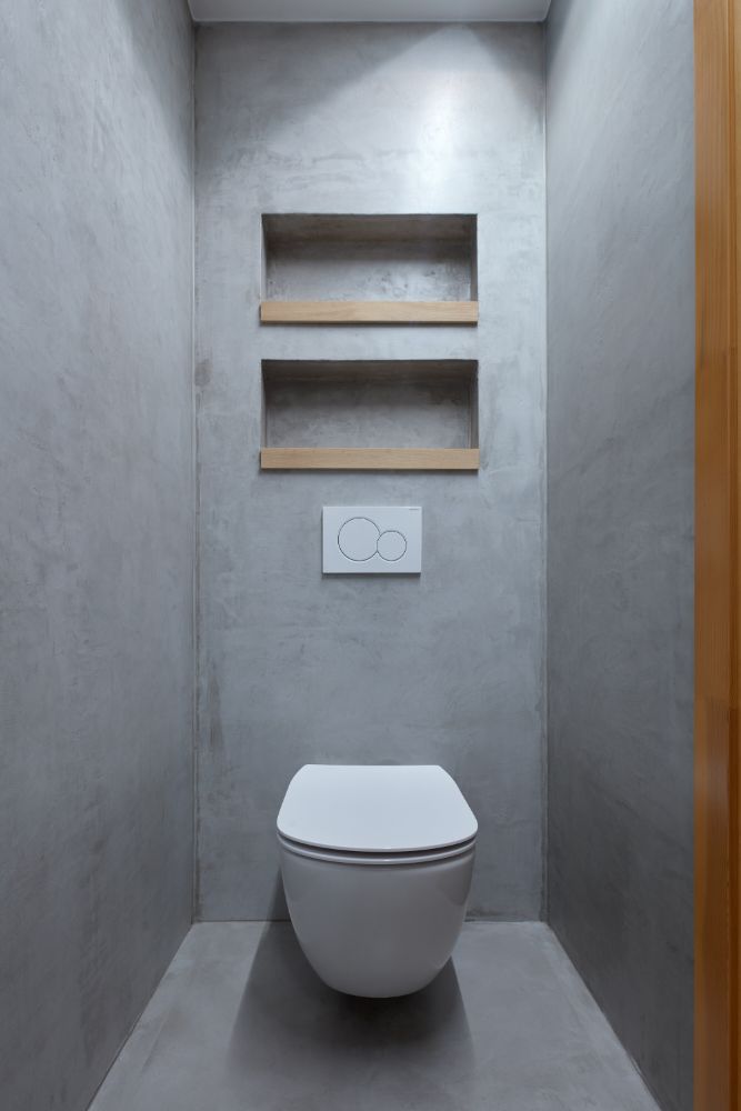 Small narrow area with toilet bowl.
