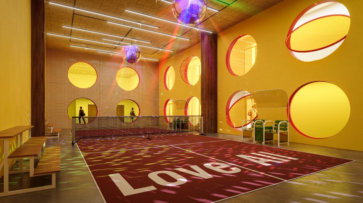 The Stadium is designed with a visual connection to the karaoke bar and fitness rooms through circular windows and a balcony for fans.