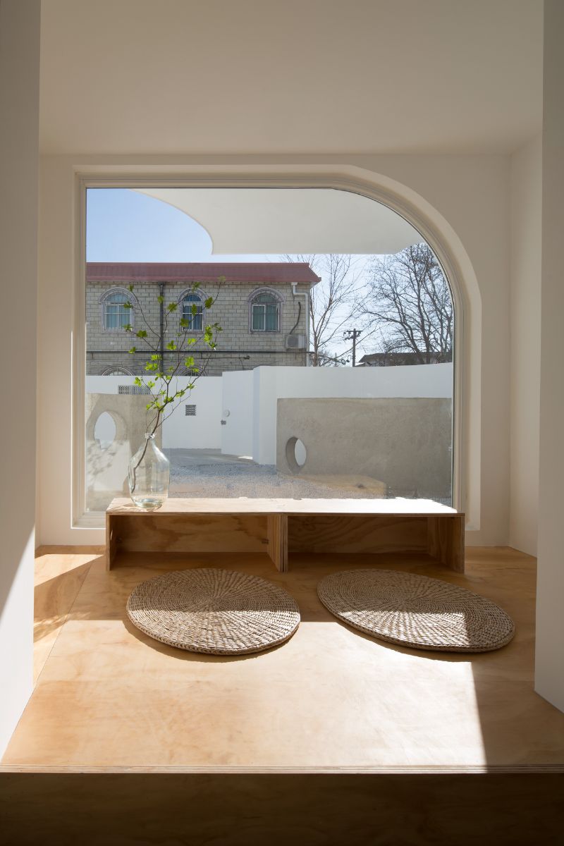 The tea room, with its large glass quarterly arc window and view of the courtyard.