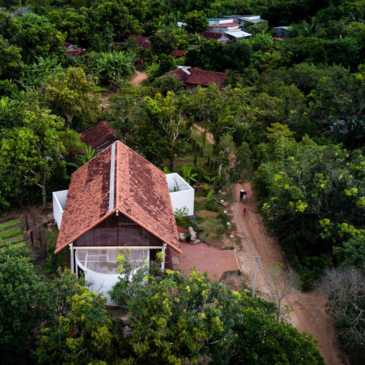 An aerial view of the house surrounded with lush greenery.