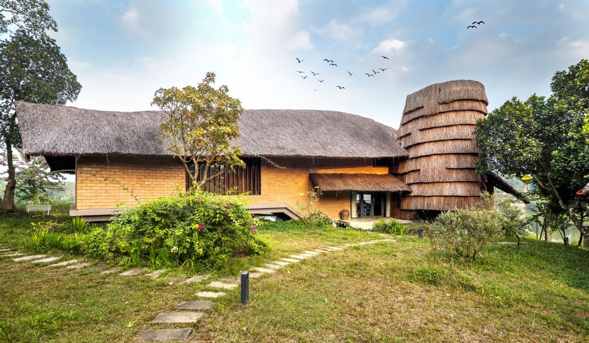 The house's side view shows a thatched roof that casts its own shadow.