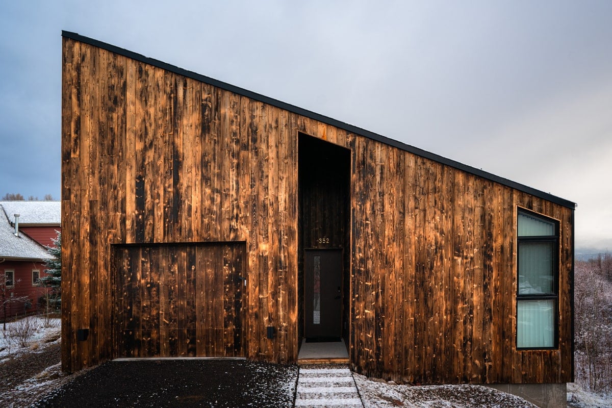 The main entrance of the house in finished wood surface both exterior and interior.