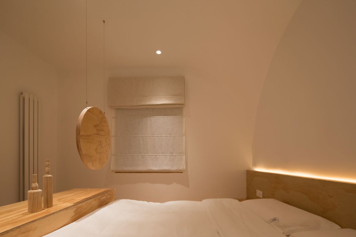 A guestroom in white paint and hardwood doors and furniture.