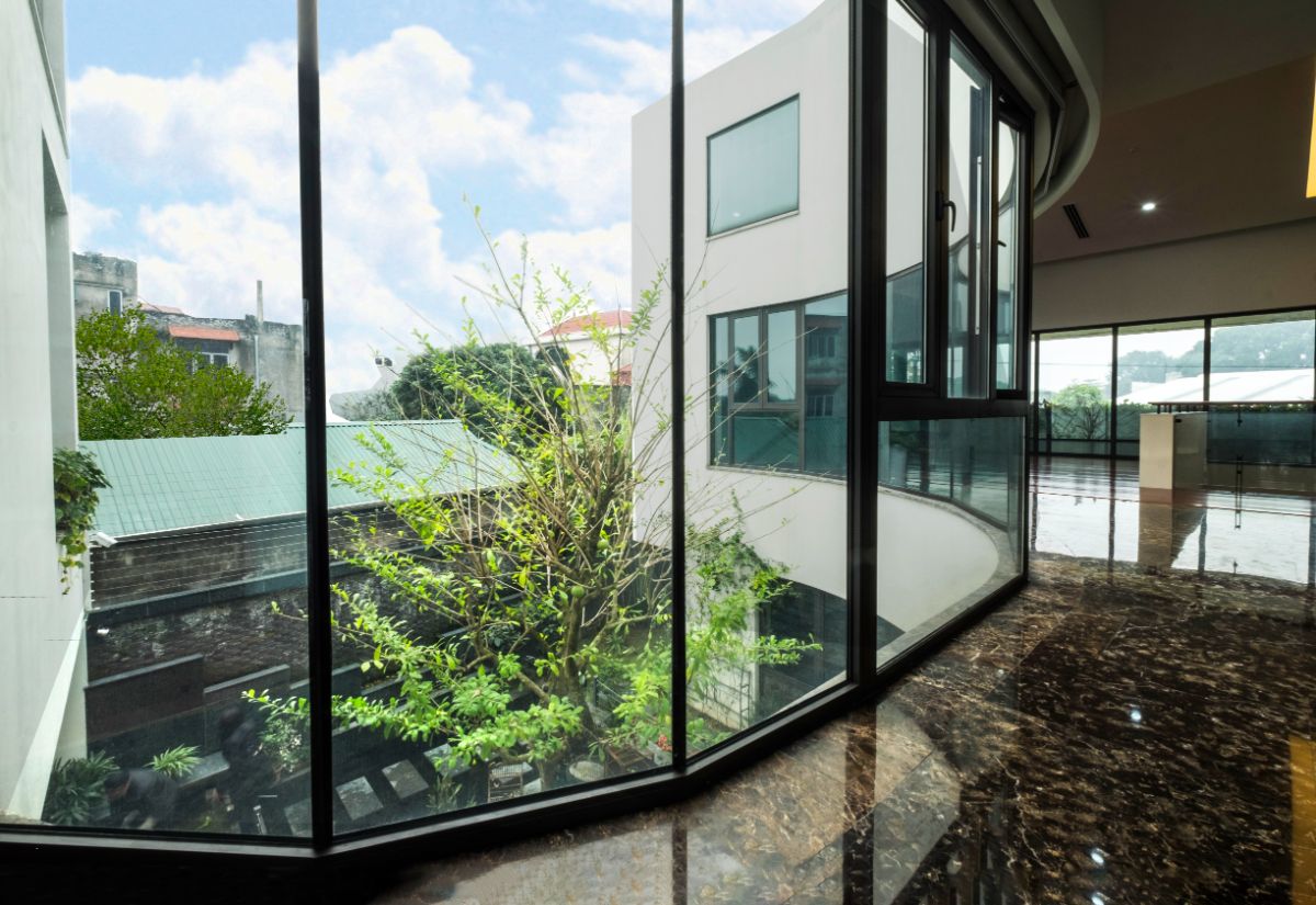 A large glass wall system extends the view from the second floor to the ground floor in an open space from the second floor.