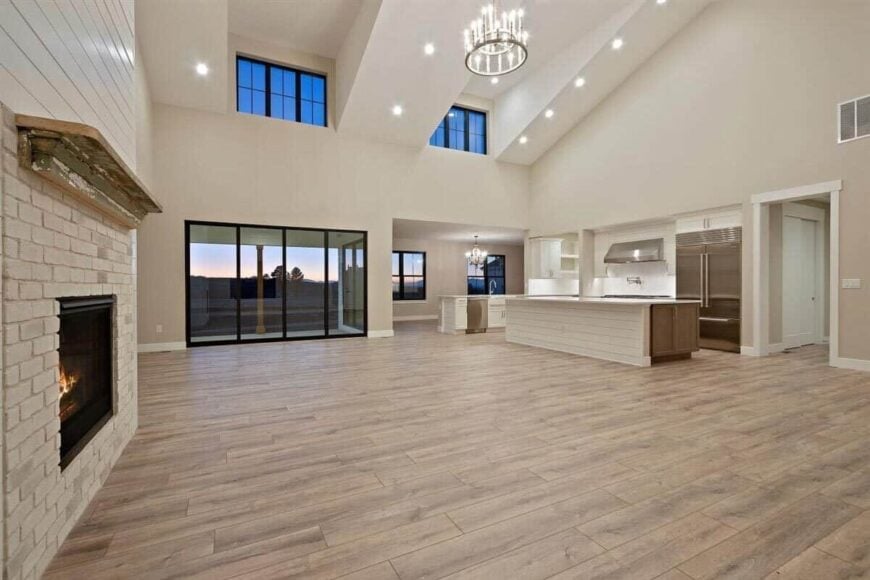 A vaulted ceiling fitted with recessed lights and a chandelier crowns the open living space.